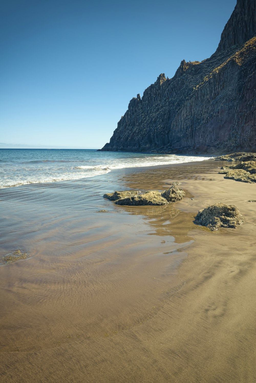 seashore under blue sky during daytime