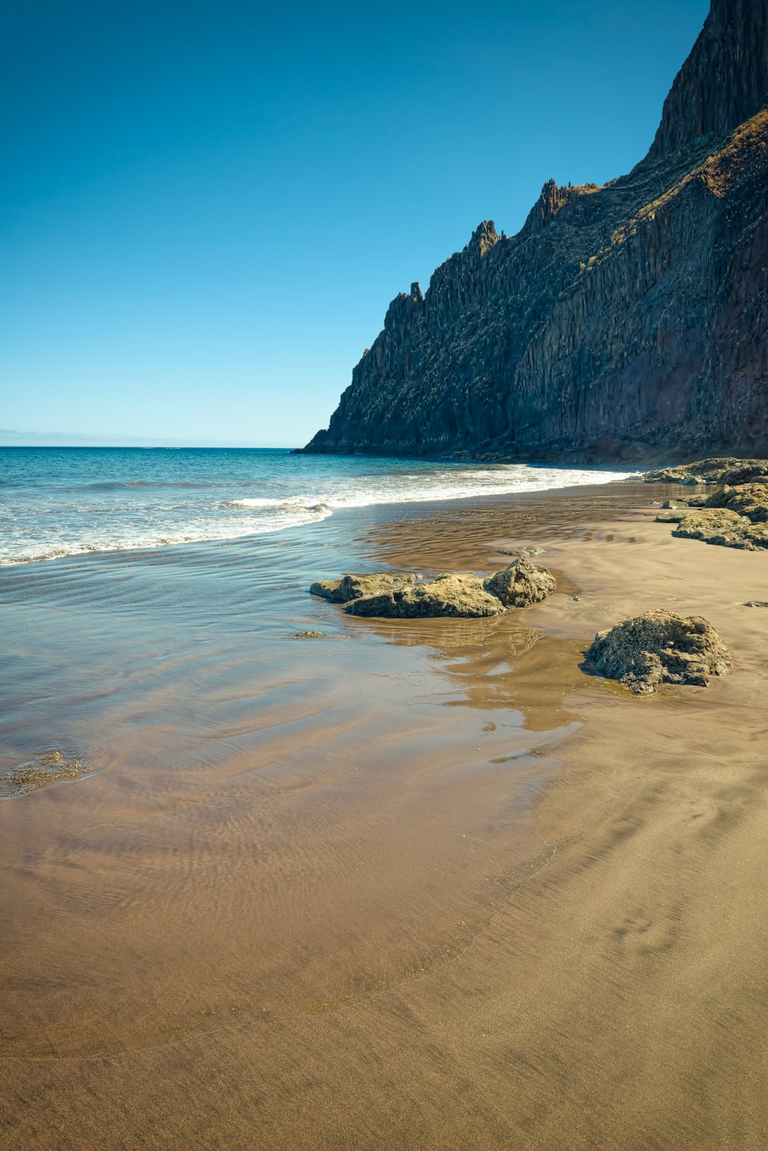 seashore under blue sky during daytime