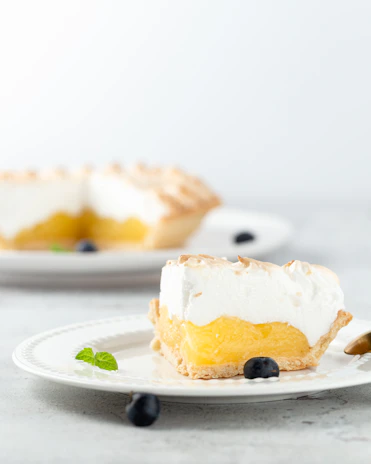 An inviting slice of lemon meringue pie with toasted peaks and a buttery crust