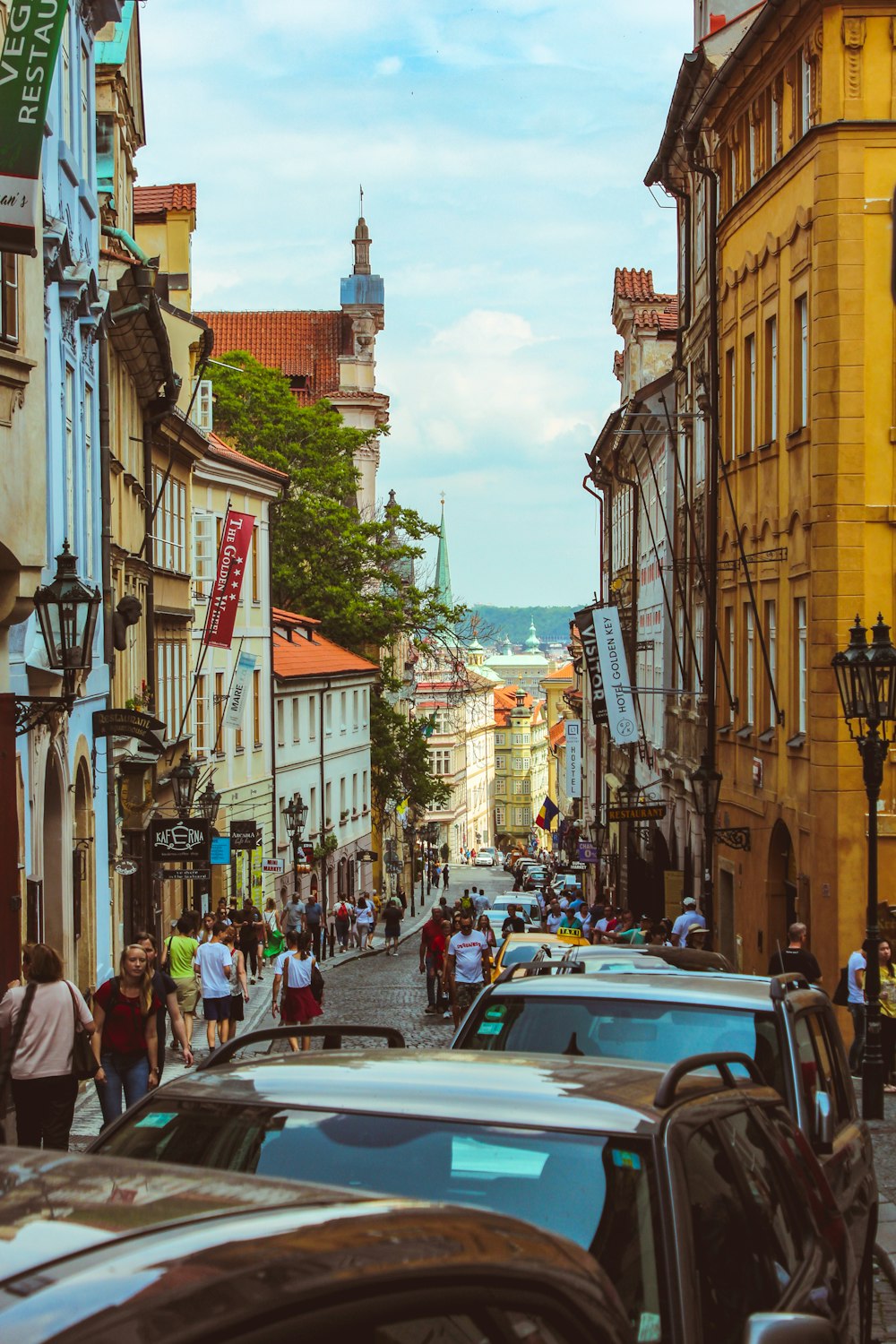 people and vehicles on street during daytime