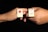 Two hands each hold a rectangular pin with illustrations. The left pin features a lollipop with lips, while the right pin displays a pair of legs in red shoes and a skirt. Both pins have the word 'Lolita' written on them and are set against a black background.