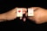 Two hands each hold a rectangular pin with illustrations. The left pin features a lollipop with lips, while the right pin displays a pair of legs in red shoes and a skirt. Both pins have the word 'Lolita' written on them and are set against a black background.