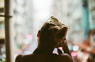 Close-up of a sleek, modern hairstyle with soft city lights in the background
