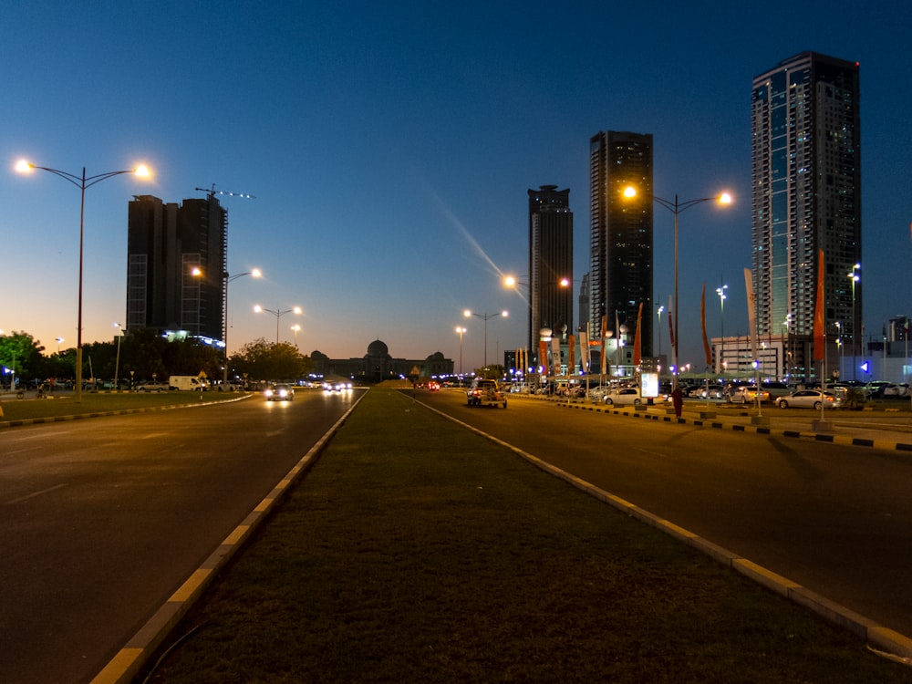 concrete road between buildings at nighttime