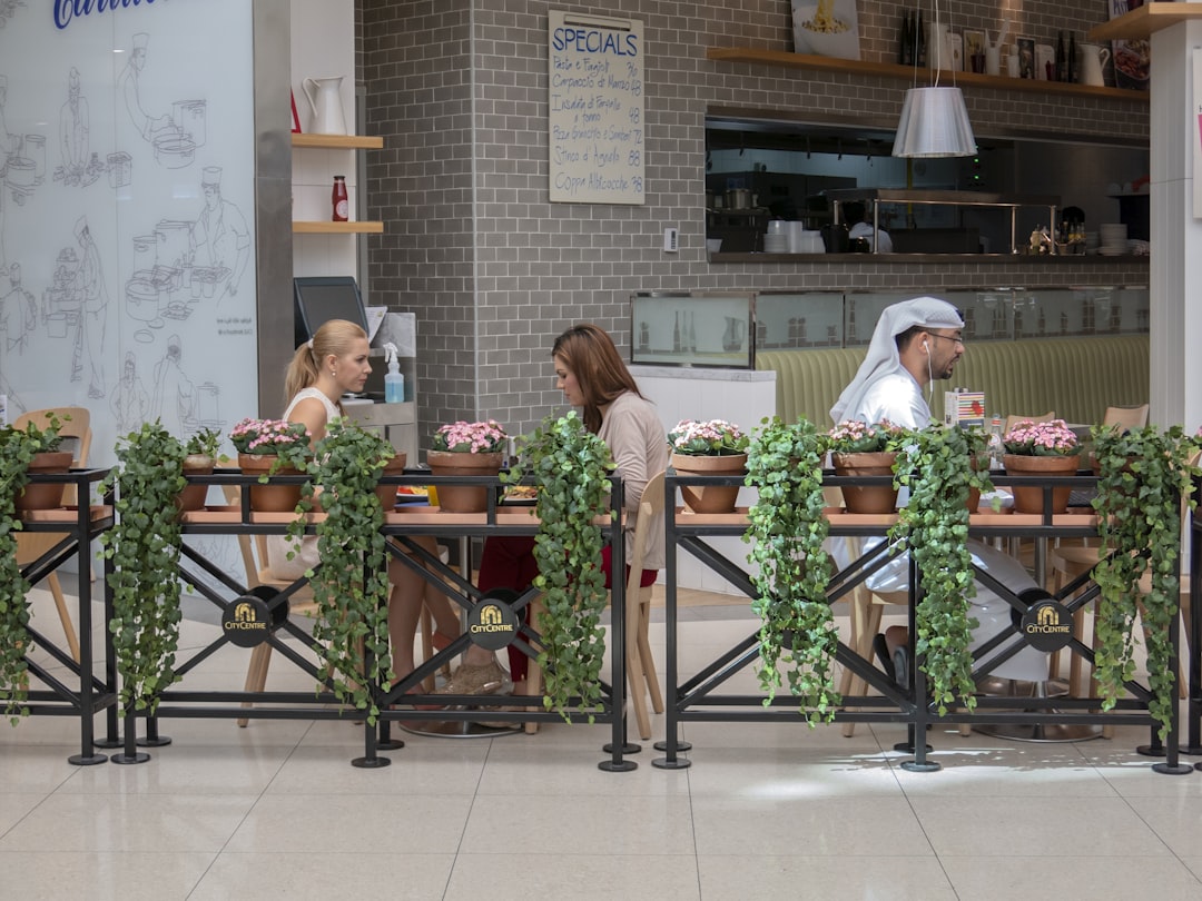 two women eating outside,