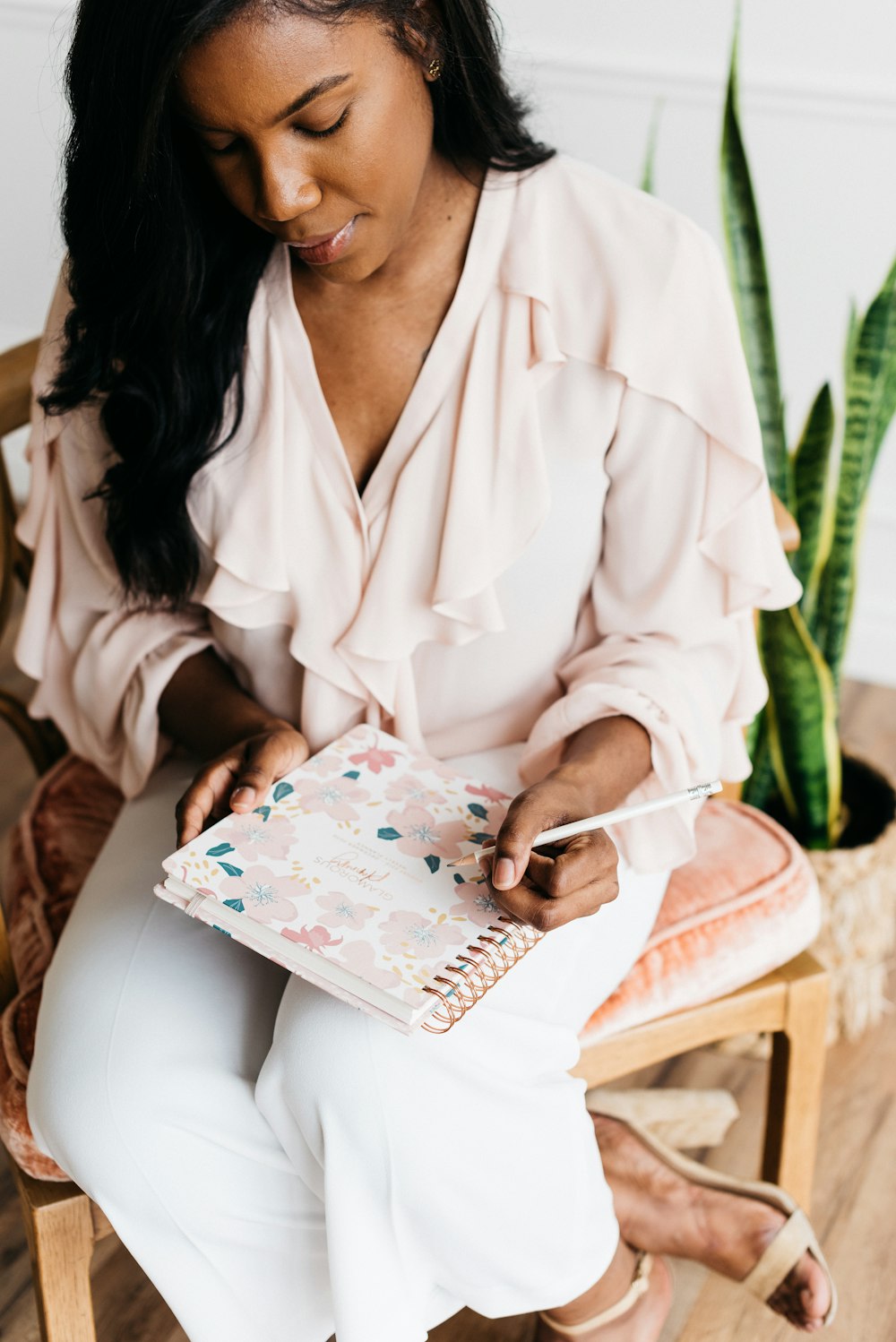 woman siting holding pencil