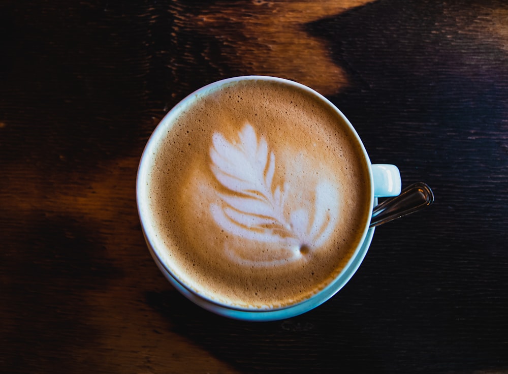 filled cup with teaspoon on saucer