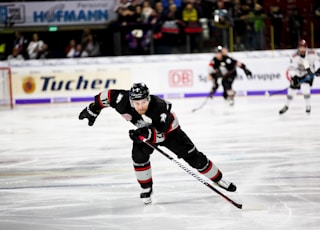 ice hockey player sliding on ice rink