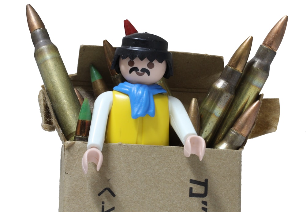 man action figure in bullet box