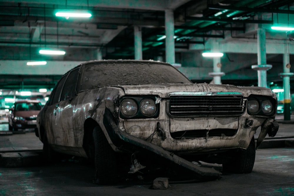 unwashed white sedan parked inside building's parking lto