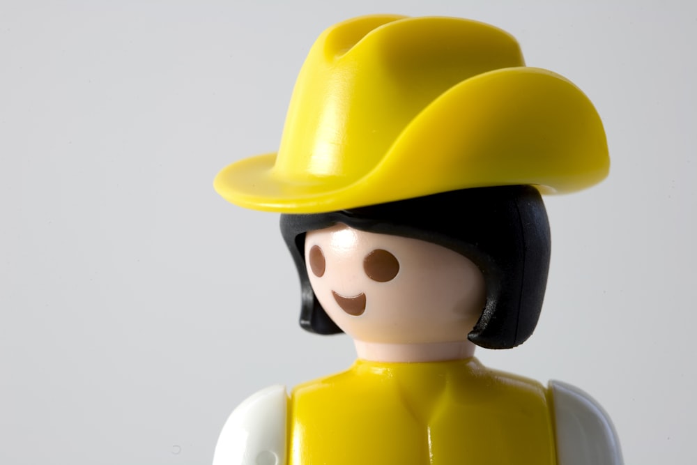 black-haired female wearing yellow hat figure