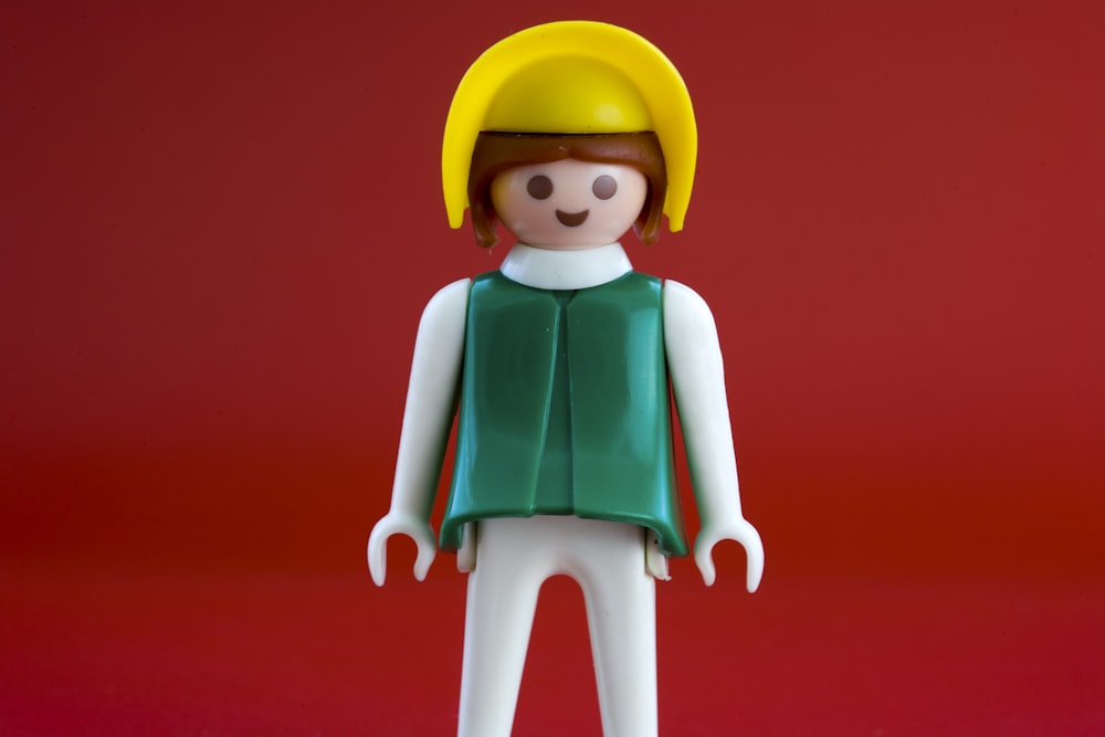 woman in green shirt and yellow hat Lego minifig