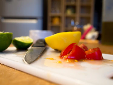 A vibrant kitchen scene showing Cutora shears resting beside colorful vegetables ready to be prepared.