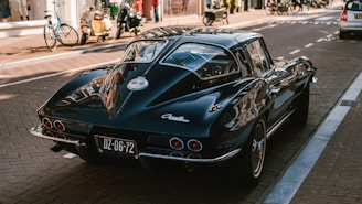 parked black coupe on road