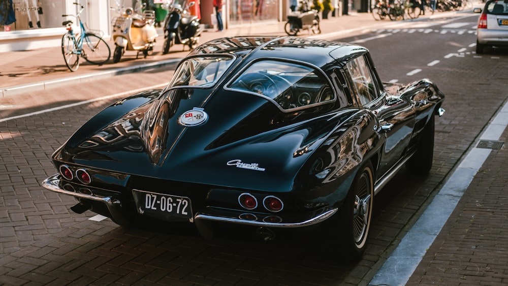 parked black coupe on road