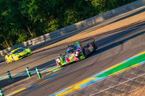 A high-energy image of cars racing on a track.