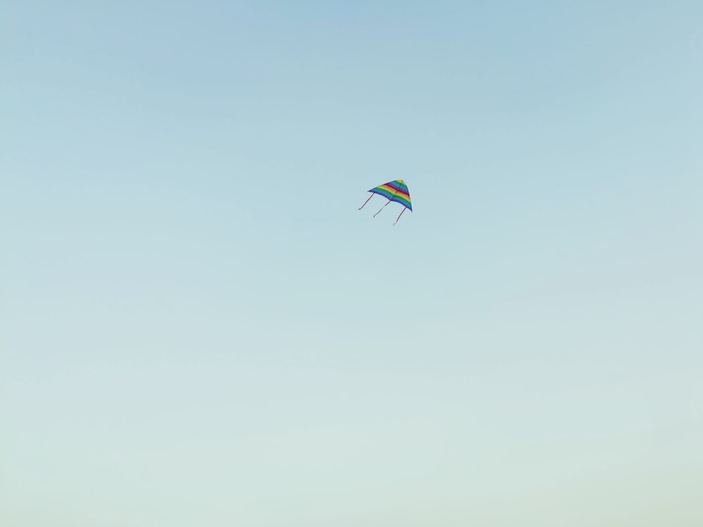 blue, orange, and red striped kite