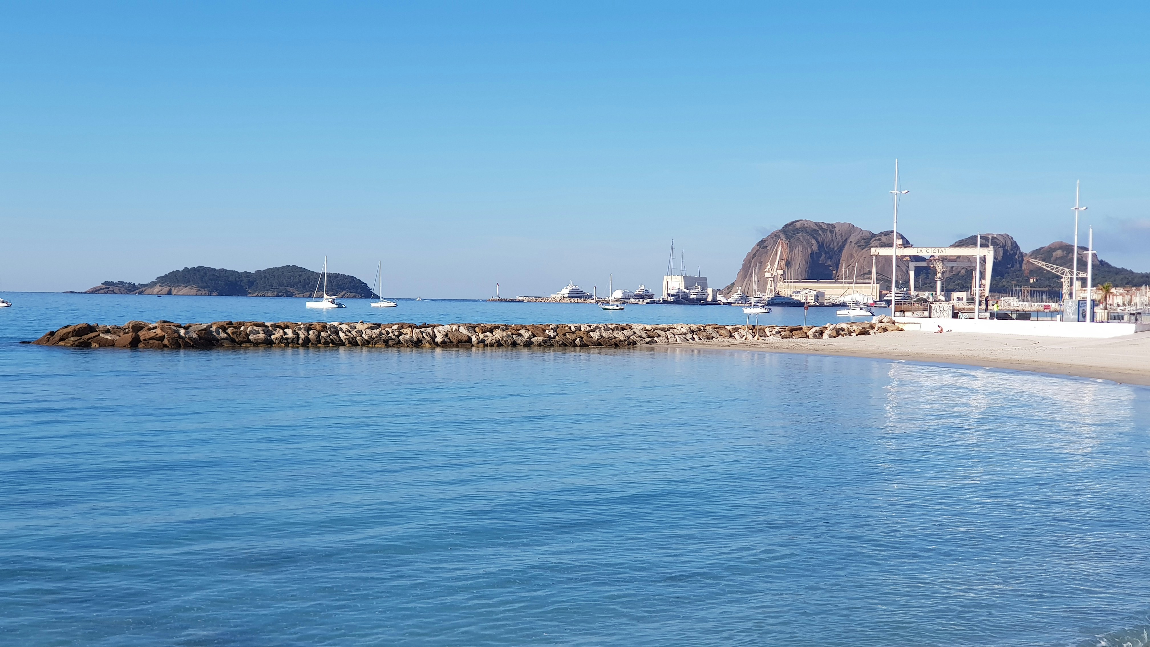 blue beach under clear blue sky