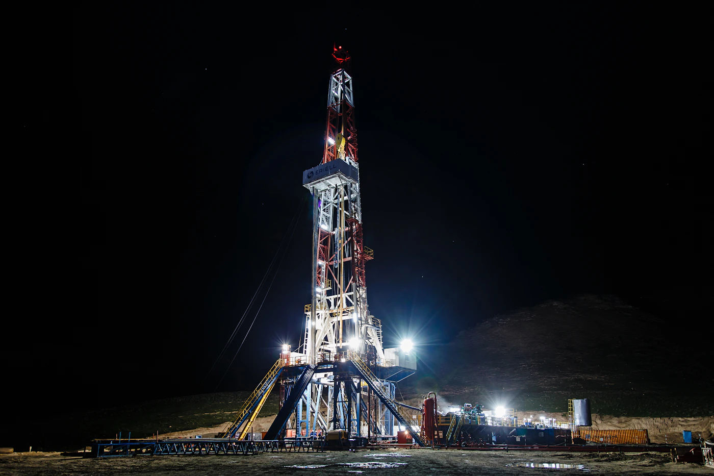 An offshore structure lit at night, representing caution and the common mistakes to avoid in the first day after a maritime injury