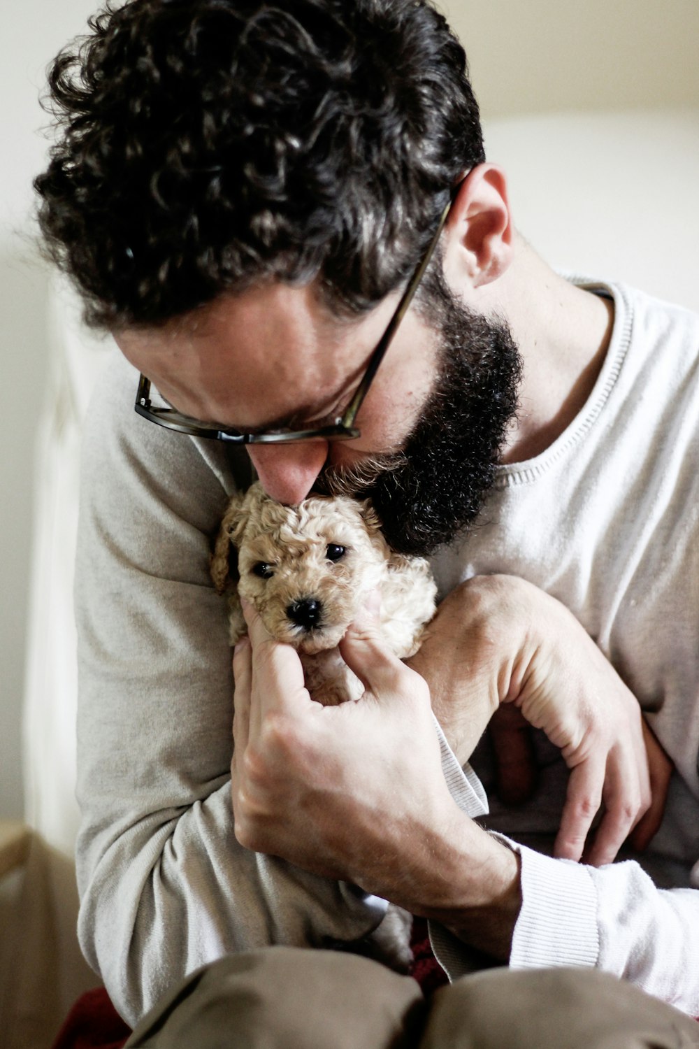 man hugging puppy