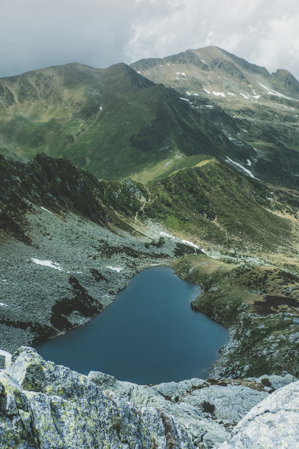 red and white mountain near lake