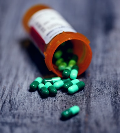 shallow focus photography of prescription bottle with capsules