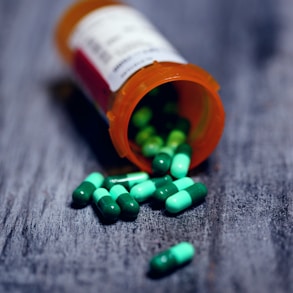 shallow focus photography of prescription bottle with capsules