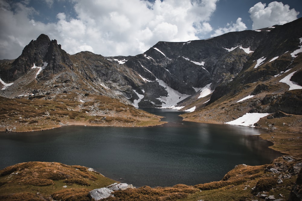 gray and brown mountains and lake