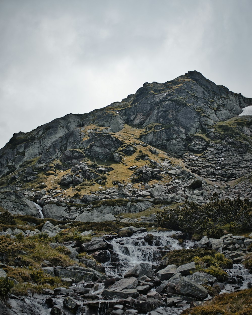 rocks and mountain under white sky