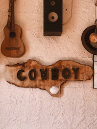 Rustic western-themed wall decor featuring leather and wood accents.