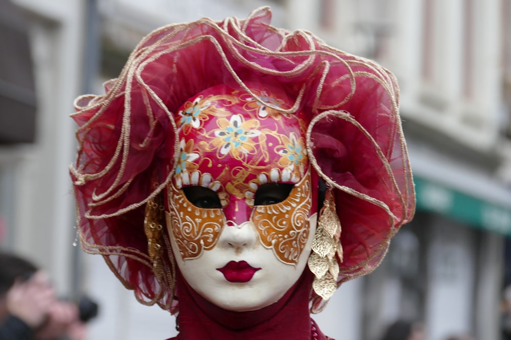 person in white and red floral mask