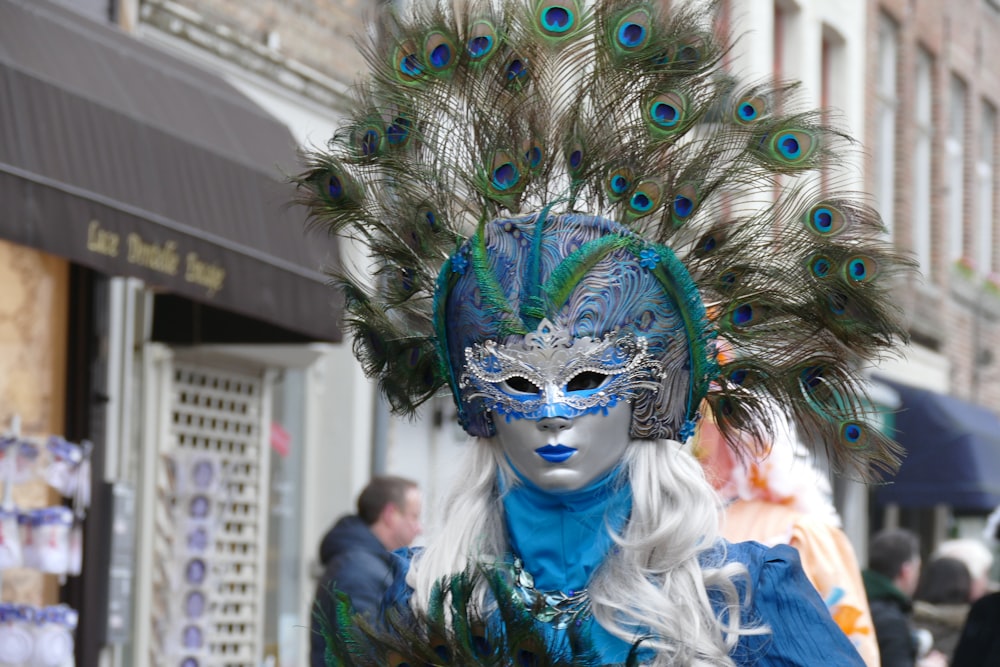 woman wearing gray and green peacock mask