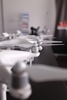 several white drones lining up on table