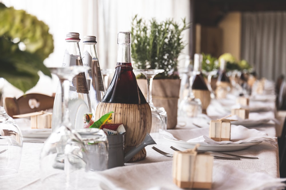 brown glass bottle beside wine glass