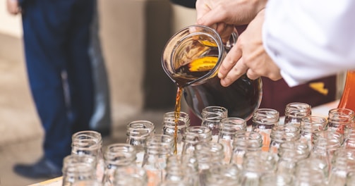 person filing glass bottle lot