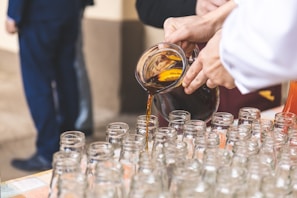 person filing glass bottle lot