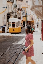 woman crossing the street near cable trains