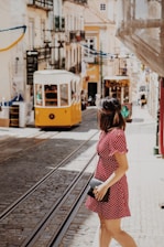 woman crossing the street near cable trains