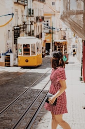 woman crossing the street near cable trains