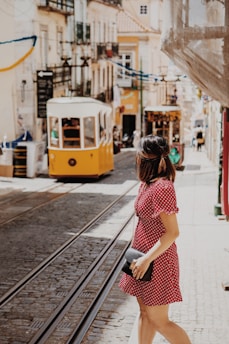 woman crossing the street near cable trains