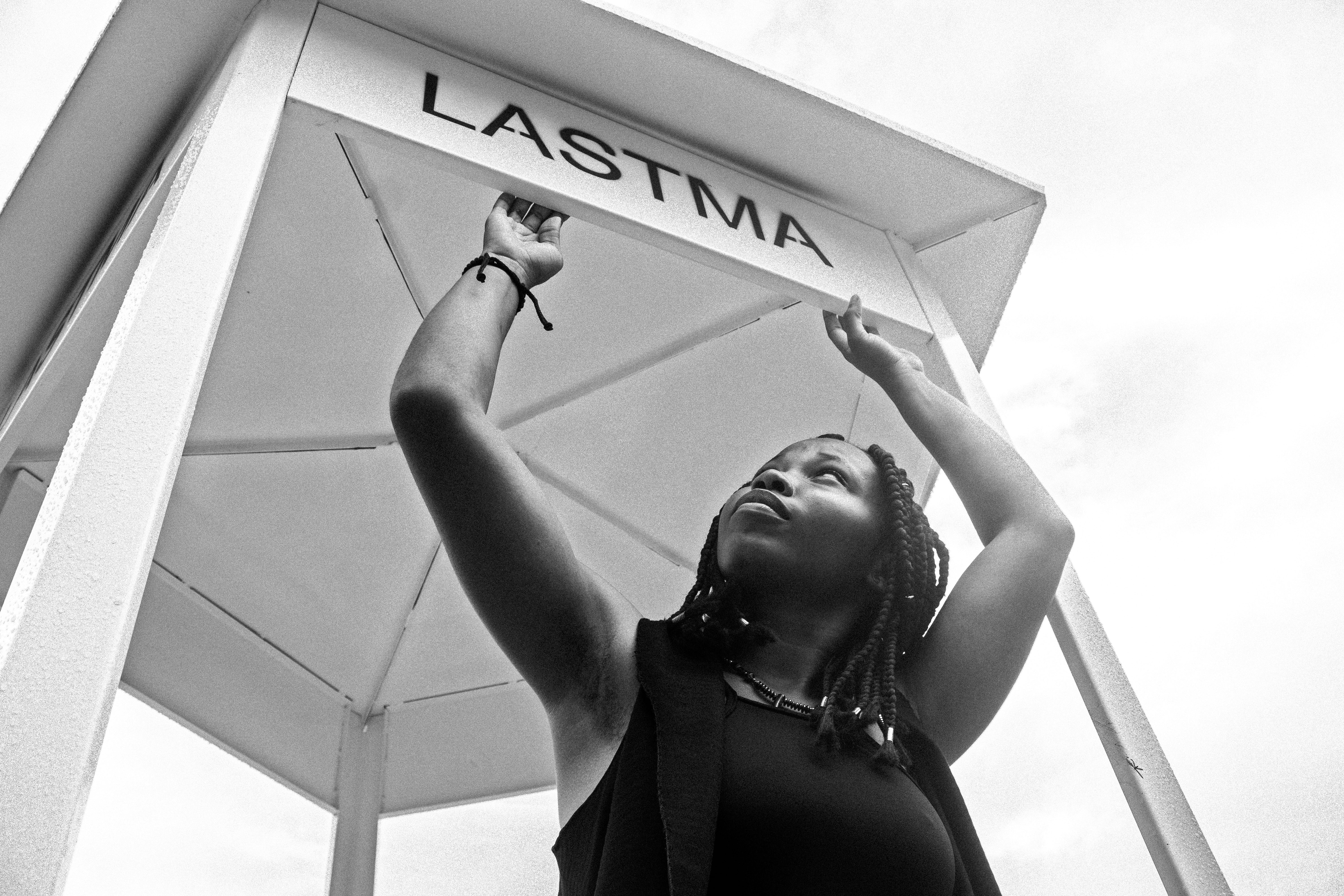 grayscale photography of woman under canopy