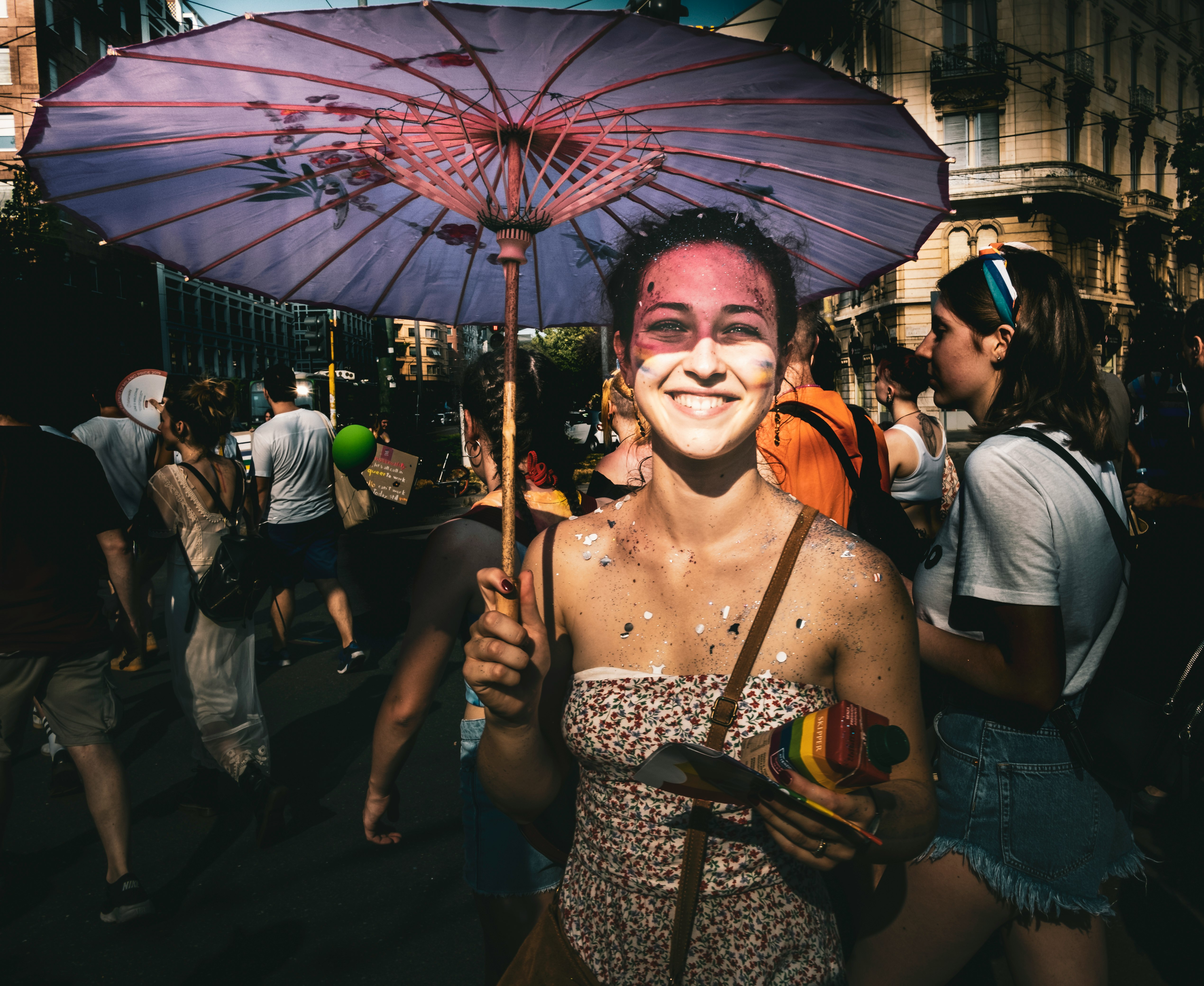 smiling woman holding umbrella