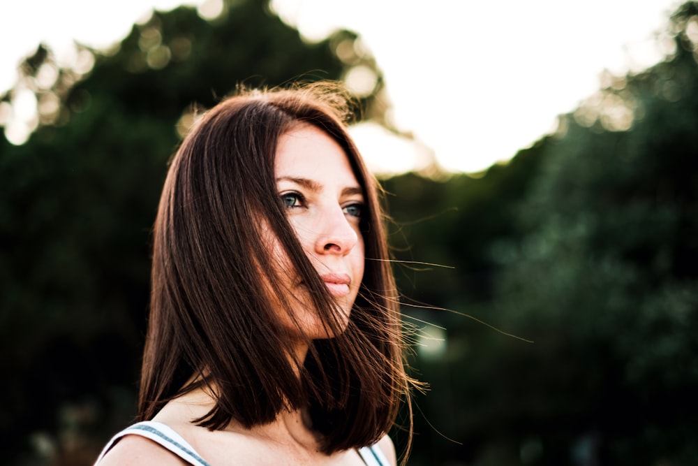 closeup photo of woman standing near trees