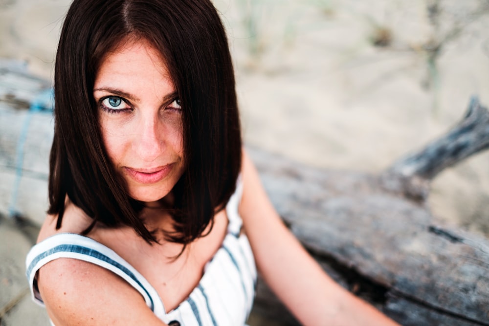 woman wearing white and blue pinstriped sleeveless top