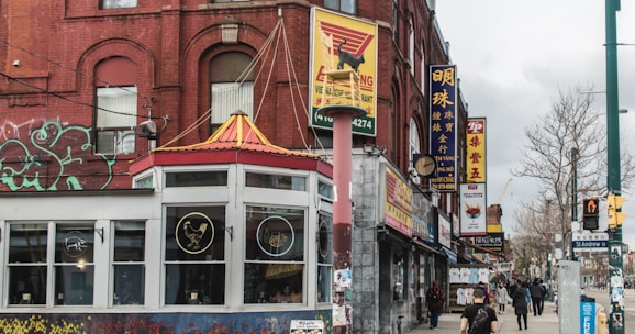 A vibrant street scene showing various small businesses in a city neighborhood.