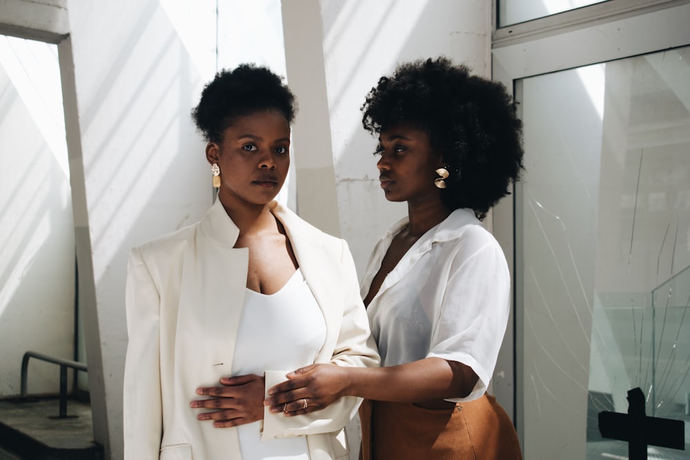 two women standing near wall