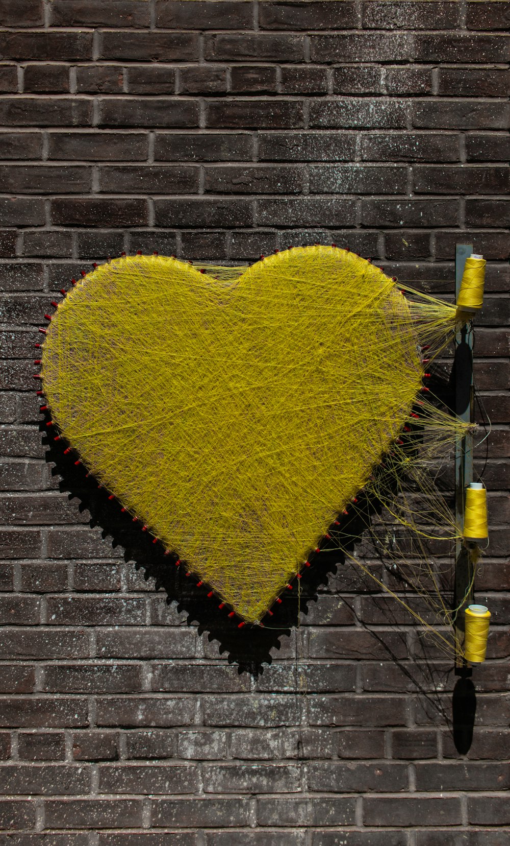 yellow thread heart wall art