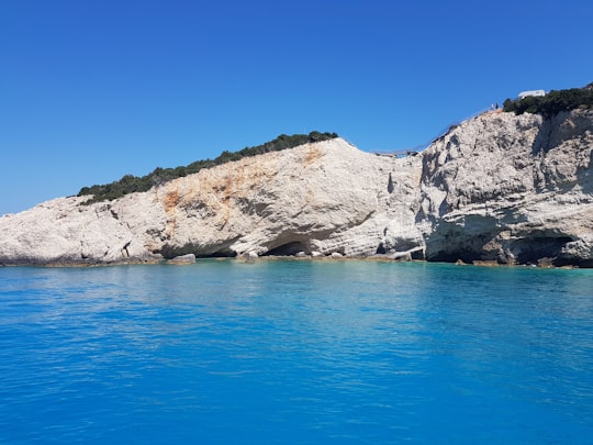 brown rock formation near body of water in Porto Katsiki Greece