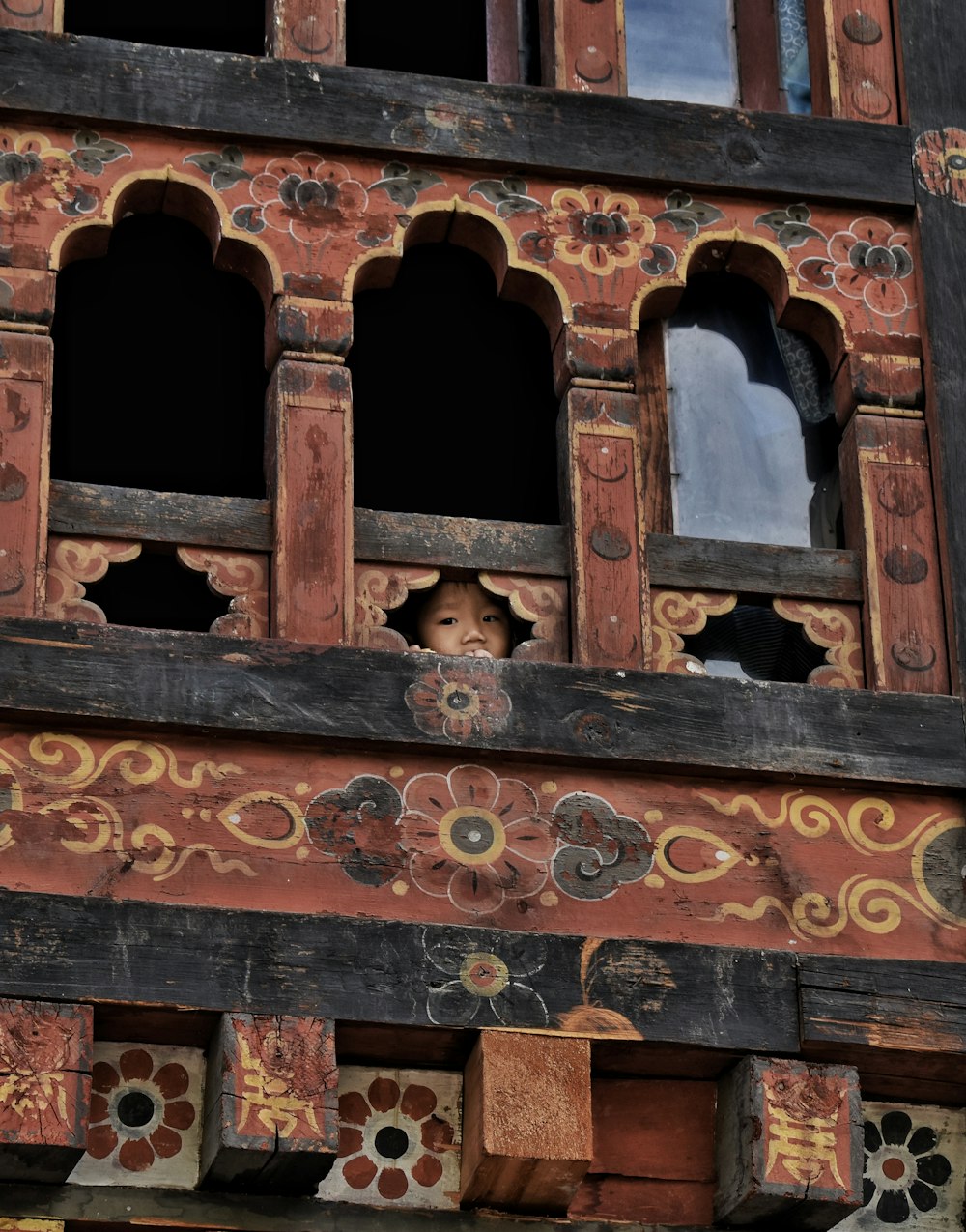 child's face in building's hole