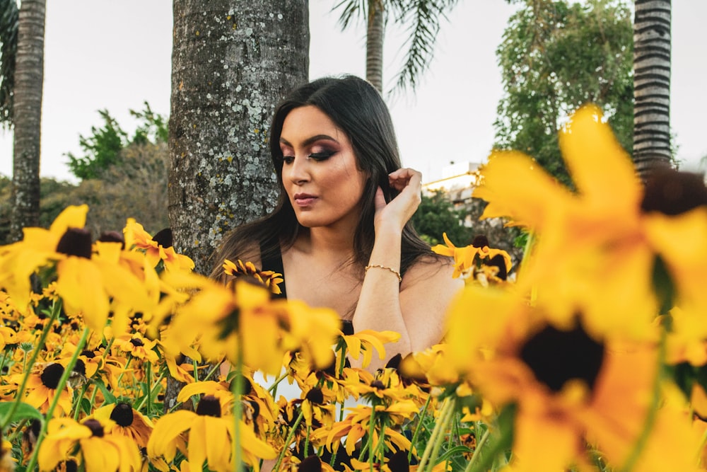 woman beside yellow flowers